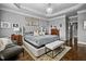 Serene main bedroom featuring a tray ceiling, chandelier, and a tufted headboard bed at 39 Wood Stork Ct, Clayton, NC 27520