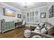 Cozy home office with leather sofa, hardwood floors, and natural light for a productive workspace at 39 Wood Stork Ct, Clayton, NC 27520