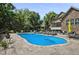 Relaxing in-ground pool with surrounding stone patio and outdoor furniture, great for leisure and enjoying the outdoors at 39 Wood Stork Ct, Clayton, NC 27520