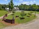 Aerial view of estate featuring home, guest house, brick entrance, gazebo, and circular driveway at 4050 Culbreth Rd, Stem, NC 27581