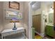 Colorful bathroom with a green vanity and decorative accents at 4050 Culbreth Rd, Stem, NC 27581