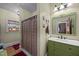 Unique bathroom featuring a colorful stained glass window and a green vanity at 4050 Culbreth Rd, Stem, NC 27581