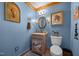 Bathroom featuring rustic-style cabinet and a decorative mirror, creating a unique look at 4050 Culbreth Rd, Stem, NC 27581