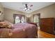Comfortable bedroom with hardwood floors, windows, and a ceiling fan at 4050 Culbreth Rd, Stem, NC 27581