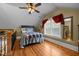 Large attic bedroom with a bed and an overlook to the staircase below at 4050 Culbreth Rd, Stem, NC 27581