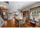 Eat-in dining room features hardwood floors, chandelier, and open layout to kitchen at 4050 Culbreth Rd, Stem, NC 27581