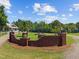 Beautiful entrance to a farm estate featuring brick, lamps, and green landscaping at 4050 Culbreth Rd, Stem, NC 27581
