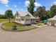 Home with inviting porch, manicured lawn, and white picket fence offers a charming and welcoming appeal at 4050 Culbreth Rd, Stem, NC 27581