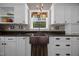 Charming kitchen features a copper sink, white cabinets, and granite countertops at 4050 Culbreth Rd, Stem, NC 27581