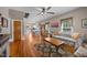 Comfortable living room features hardwood floors and fireplace opens to kitchen and dining area at 4050 Culbreth Rd, Stem, NC 27581