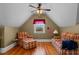 Charming room with vaulted ceilings, wood floors, comfortable plaid furnishings, and a bright window view at 4050 Culbreth Rd, Stem, NC 27581