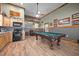 Recreation room featuring a full kitchen, wood cabinets and a billiards table for entertainment at 4050 Culbreth Rd, Stem, NC 27581