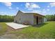 Exterior view of a shed, highlighting its structure, patio and surrounding landscape at 4050 Culbreth Rd, Stem, NC 27581