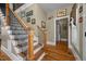 Staircase with wooden stairs, black iron spindles, and wooden handrail with hardwood floor at 4050 Culbreth Rd, Stem, NC 27581