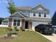 Charming two-story home with stone accents, a well-manicured lawn, and an attached two-car garage at 4108 Cross Timber Ln, Raleigh, NC 27603