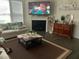 A cozy living room with a fireplace, a large screen television, and a comfortable seating area at 4108 Cross Timber Ln, Raleigh, NC 27603