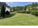 Expansive backyard with lush lawn and privacy hedge at 421 Braxman Ln, Holly Springs, NC 27540
