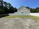 Spacious backyard with a well-maintained lawn, enclosed by a white privacy fence, providing a secure outdoor space at 421 Braxman Ln, Holly Springs, NC 27540