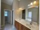 Large primary bathroom with double sinks, a large mirror, and a separate tub at 421 Braxman Ln, Holly Springs, NC 27540