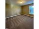 Spacious carpeted bedroom with natural light streaming through the window at 421 Braxman Ln, Holly Springs, NC 27540
