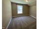 Bedroom featuring a large window that provides natural light and plush carpeting at 421 Braxman Ln, Holly Springs, NC 27540