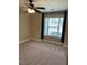 Cozy bedroom with carpet, ceiling fan, and natural light from large window at 421 Braxman Ln, Holly Springs, NC 27540