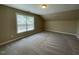 Large bonus room featuring a window and plush carpeting at 421 Braxman Ln, Holly Springs, NC 27540