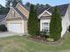 Home with well-maintained lawn, garden beds and mature evergreens at 421 Braxman Ln, Holly Springs, NC 27540