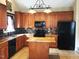 Modern kitchen featuring granite countertops, tile backsplash, and stainless-steel appliances at 421 Braxman Ln, Holly Springs, NC 27540