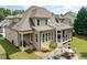 Aerial view of the backyard with a brick patio, outdoor dining, and a cozy screened-in porch at 4228 Fawn Lily Dr, Wake Forest, NC 27587