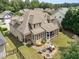 Beautiful aerial view showcasing the home's backyard with a patio, fire pit, and screened-in porch at 4228 Fawn Lily Dr, Wake Forest, NC 27587