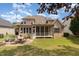 Lovely backyard with a brick patio, outdoor dining, a screened porch, and a built-in fire pit at 4228 Fawn Lily Dr, Wake Forest, NC 27587