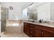 Bathroom featuring a glass-enclosed shower, soaking tub, and double vanity at 4228 Fawn Lily Dr, Wake Forest, NC 27587