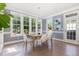 Bright dining room with large windows and hardwood floors overlooking the backyard at 4228 Fawn Lily Dr, Wake Forest, NC 27587