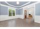 Formal dining room with large windows, chair rail and a view into the foyer at 4228 Fawn Lily Dr, Wake Forest, NC 27587