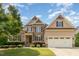 Charming two-story home with a stone facade, well-manicured lawn, and a two-car garage at 4228 Fawn Lily Dr, Wake Forest, NC 27587