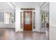 Elegant foyer featuring a decorative wood door with sidelights and transom window at 4228 Fawn Lily Dr, Wake Forest, NC 27587