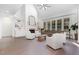 Bright living room with hardwood floors, a fireplace, built-in bookshelves, and large windows at 4228 Fawn Lily Dr, Wake Forest, NC 27587