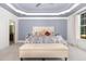 Spacious main bedroom featuring a tray ceiling, soft carpet, and a sitting area at 4228 Fawn Lily Dr, Wake Forest, NC 27587