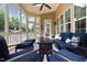Inviting screened porch featuring plush furniture and a cozy fire table at 4228 Fawn Lily Dr, Wake Forest, NC 27587