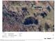 Aerial view of wooded property with pond, buildings and boundaries outlined at 4254 Bowmantown Rd, Roxboro, NC 27574