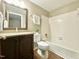 Bathroom showcasing a dark vanity with a stone countertop and a shower-tub combo at 4324 Halliwell Dr, Raleigh, NC 27606
