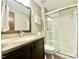 Bathroom featuring a dark vanity with granite countertop, glass shower, toilet and mirror at 4324 Halliwell Dr, Raleigh, NC 27606