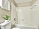 Bathroom featuring white tile shower over tub with chrome shower head and fixtures at 4324 Halliwell Dr, Raleigh, NC 27606