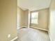 This empty bedroom features neutral walls and carpet and a window letting in plenty of natural light at 4324 Halliwell Dr, Raleigh, NC 27606