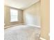 This is an empty bedroom with neutral walls and carpet. A window lets in plenty of natural light at 4324 Halliwell Dr, Raleigh, NC 27606