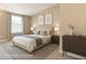 This virtually staged bedroom features warm neutral colors and abundant natural light from a large window at 4324 Halliwell Dr, Raleigh, NC 27606