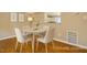 Cozy dining area with modern furnishings and a view into the kitchen at 4324 Halliwell Dr, Raleigh, NC 27606