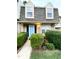 Charming townhome with a blue front door, black shutters, and manicured landscaping at 4324 Halliwell Dr, Raleigh, NC 27606