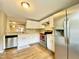 Well-lit kitchen with white cabinets, stainless steel appliances, and a window over the sink at 4324 Halliwell Dr, Raleigh, NC 27606
